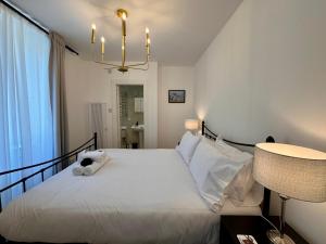 a bedroom with a white bed with a stuffed animal on it at Glenrigh House - The Garden Flat in Fort William
