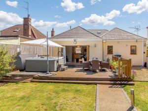 a backyard with a hot tub and a house at 3 Bed in Kings Lynn oc-43259 in Dersingham