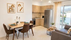 a kitchen and living room with a table and a couch at Athinais Karystos in Karistos