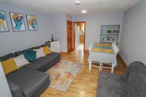 a living room with a couch and a table at Tí Maolla in Hollymount +8 photos