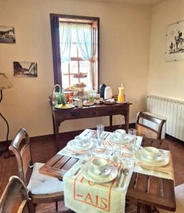 a dining room table with plates and dishes on it at Quinta do Pomarinho - Arouca in Arouca