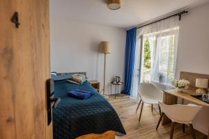 a bedroom with a bed and a table and chairs at Dom Wypoczynkowy ANNA - pobyty również B&B in Kołobrzeg