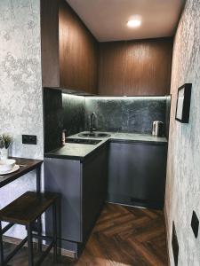 a kitchen with a sink and a counter top at Skersgatvio Apartmentai in Zarasai