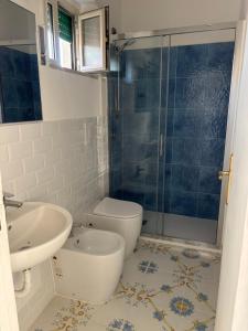 a bathroom with a toilet and a sink and a shower at Isabella Massalubrense in Massa Lubrense +26 photos