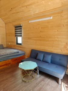 a room with a couch and a bed and a table at GiGi's Homestay & Coffee in Phú Xá