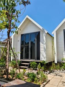 a house with large glass doors on it at GiGi's Homestay & Coffee in Phú Xá