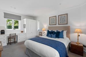 a bedroom with a large bed and a desk at Cadnam Lodge in Cadnam