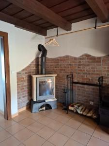 a brick fireplace in a living room with a tv at Chata DOBROTKA in Liptovský Mikuláš