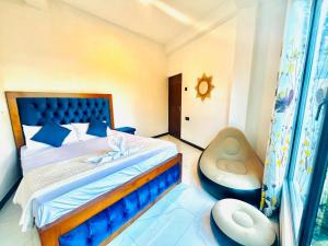 a bedroom with a bed and a chair at Lavenia Mountain Holiday home in Bandarawela