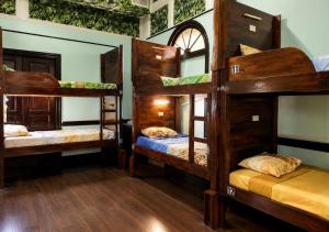 a room with three bunk beds in a house at Hostel Museo Relic in Panama City