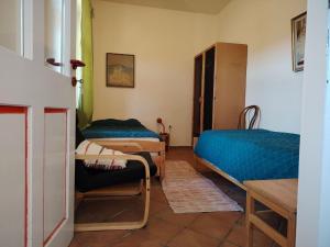 a room with two beds and a chair in it at Bacchus-hof in Báta