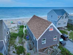 an aerial view of a house and the beach at Pet-Friendly Private Beach Oceanfront Cottage in Charlestown