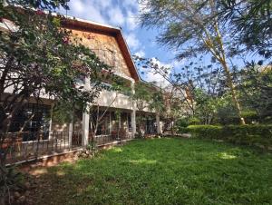 a building with a yard in front of it at Entebbe Gardens Resort in Kitengela 