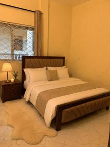 a bedroom with a large bed and a window at Iconic lux living in Malindi