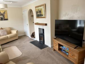 a living room with a large flat screen tv at Thorntons House in Northallerton