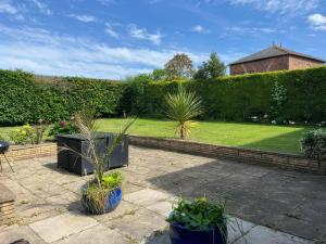 a garden with potted plants on a patio at Thorntons House in Northallerton