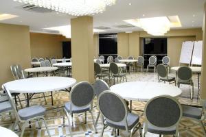 a conference room with tables and chairs in it at Blossom Hotel Dhaka in Dhaka
