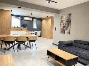 a living room with a couch and a table at Platinum Apartment in Wałbrzych