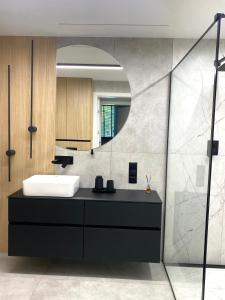 a bathroom with a sink and a mirror at Platinum Apartment in Wałbrzych