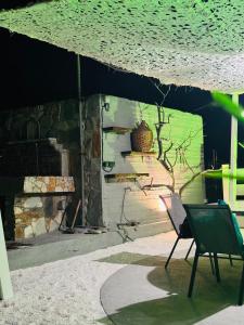 a chair sitting under an umbrella in front of a building at Faidrahouse in Alyki