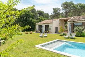a garden with a swimming pool and a house at La Bergerie du Roy-Chambres D'hôtes- in Rognes