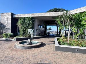 a statue of a woman in a fountain in a courtyard at Ocean's Edge Escape! in Ballito