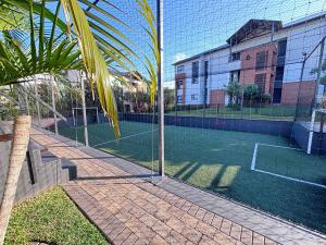 a tennis court with a net in a building at Ocean's Edge Escape! in Ballito