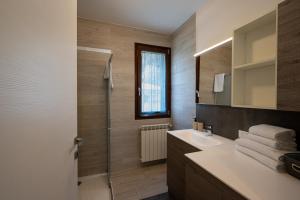 a bathroom with a sink and a shower at Casa Vacanze Costa del Sole in Riva di Solto +17 photos