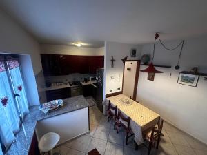 a kitchen with a table and a kitchen with a table and chairs at La Magnolia in Magenta