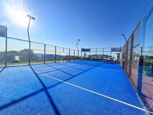 a tennis court with a net on top of it at Onyx Oasis in Ballito +12 photos
