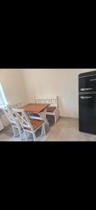 a kitchen with a table and chairs and a refrigerator at Dom Na Fali in Pasym +7 photos