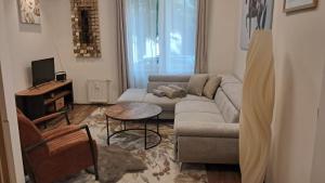 a living room with a couch and a table at Kolonáda in Poděbrady