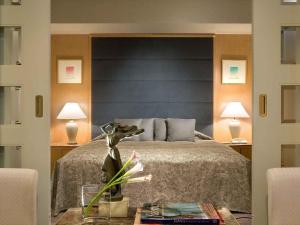 a bedroom with a bed and two lamps and a table at The Cypress Mercure Hotel Nagoya in Nagoya +44 photos