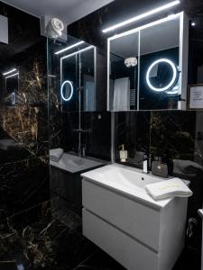a bathroom with a sink and a mirror at Lux Line Apartment in Zurich