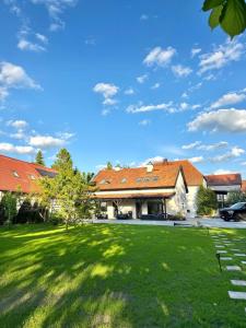 a building with a green lawn in front of it at Przystań Jeziorna in Pasym