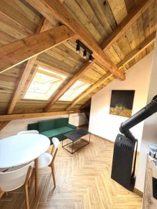 a living room with a table and a bench and a window at Przystań Jeziorna in Pasym