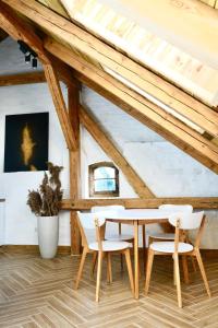 a dining room with a table and chairs in a attic at Przystań Jeziorna in Pasym
