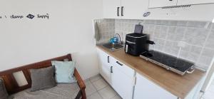 a small kitchen with a sink and a microwave at Sky Eye Studios in Kokkini Khanion