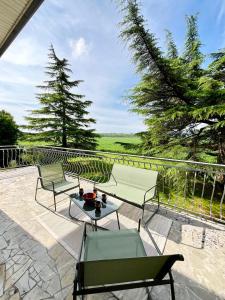 a patio with two chairs and a table at Maison familiale champêtre 8 pers in Fontet