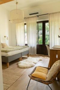 a bedroom with two beds and a chair and window at La Bergerie du Roy-Chambres D'hôtes- in Rognes +26 photos