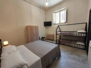 a bedroom with two bunk beds and a television at Loft Pisacane 27 - Mare e Centro a Piedi in Senigallia