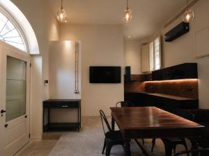a dining room with a wooden table and chairs at Loft Pisacane 27 - Mare e Centro a Piedi in Senigallia