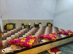 a bed with flowers on it in a room at Hotel Maharana Inn in Sehore