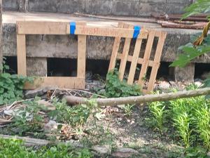 a wooden bench sitting in front of a building at KUNGHORk in Ban Nong Chaeng