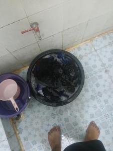 a person standing next to a toilet in a bathroom at KUNGHORk in Ban Nong Chaeng