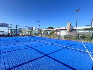 a tennis court in front of a building at Sunset & Soul in Ballito