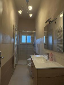 a bathroom with a sink and a toilet and a shower at Le Magnolie 1924 in Casciana Terme