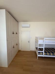 a bedroom with a bunk bed and a closet at Le Magnolie 1924 in Casciana Terme