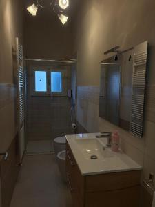 a bathroom with a sink and a shower and a toilet at Le Magnolie 1924 in Casciana Terme