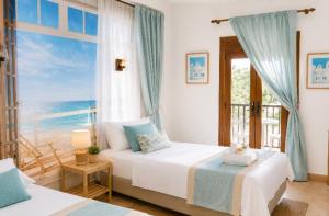 a bedroom with a bed with a view of the ocean at Oliver Santiago Mallorca in Cala Figuera